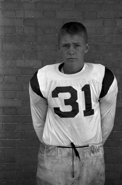 Portrait of Craig Lutey, # 31 on the Wisconsin High School football team. One of 33 images of individual members of the Wisconsin High School football team and the coaches Hal Metzen and Ed Goss.