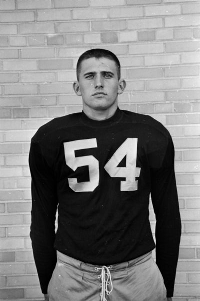 Portrait of Tom Tomlinson, #54 on the Edgewood High School team. One of 52 images of individual members of the Edgewood High School football team and the coaches Earl Wilke, Pete Olson, George Chryst, Dave Brown and managers Mike McInery, Mike Uselman, Ray Weise.