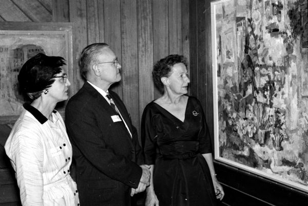 Shown viewing a painting, are, left to right: Helen Zillman, Dean Zillman, and Helen Schmedeman.