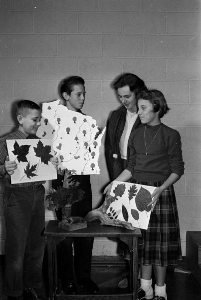 Four eighth grade students at the Immaculate Heart of Mary Catholic School during a program to show their parents what they've learned about their study of the State of Wisconsin.  Left to right:  David Sherman, John Imhoff, Pat Tomel and Susan Pressentin.