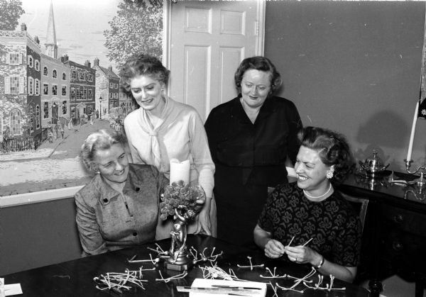 Four members of the Christ Presbyterian Women's Service League make plans for the Christmas House Tour, a benefit for church ministries. Left to right: Mrs. George Wood; Janet Neckerman, chair for ticket sales; Elizabeth Zweifel, bake sale; and Arline Houseman, working on Christmas decorations for the boutique.