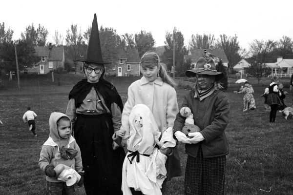 Jeff Isenring (left), Jean Cox, Nancy Willett, Jean Willett (the ghost) and Karen Olson attend the Sunset Village Community Club Halloween Party.