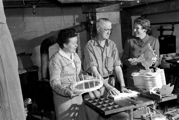 Woodcraft articles by Frank F. France will be among the many items sold at the sixth annual Homecrafters Fair at Scanlan Hall in the Madison Vocational and Adult School. He is pictured with Mina Dutton, an instructor, and Adelaide Willard, chairman of homecrafters for the University League.