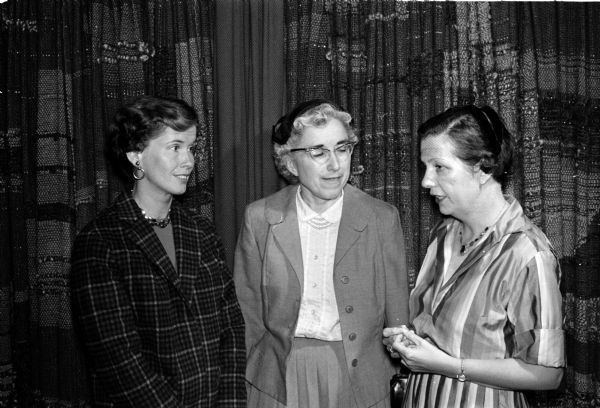 Three members of the Madison League of Women Voters chat at a league dinner. Left to right are Mrs. Henry Lardy, Mrs. Laura Munson, and Professor Clara Penniman.