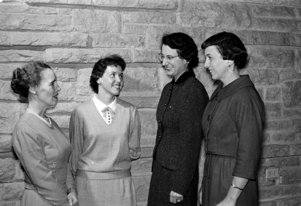 Four officers of the Madison League of Women Voters visit at a league dinner held at the Unitarian Meeting House. Left to right are: Mrs. Betty Doremus, Mrs. Mary Newgent, Mrs. Arnieta Halle, and Mrs. Mary Symon.