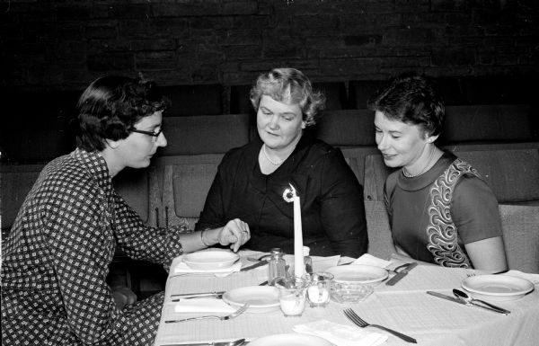 Three officers of the Middleton League of Women Voters visit at a league dinner they co-sponsored with the Madison league. Left to right are: Mrs. Roland Lehman, Mrs. Theodore Shannon, and Mrs. Constance Threinen.