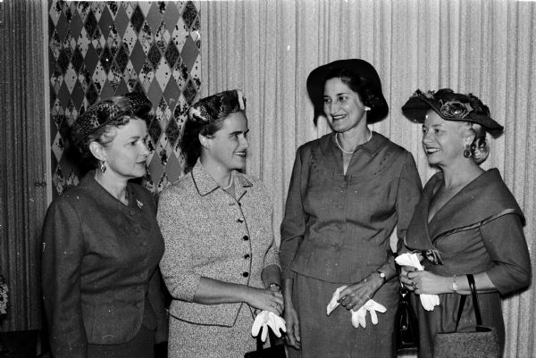 Portrait of four members of the nursing committee at the annual meeting of the Madison Visiting Nurse Service at the Maple Bluff Country Club. Left to right are: Mrs. Josephine Miller, Mrs. Adrienne Grannis, Mrs. Charline Larson, and Mrs. Virginia Hall.