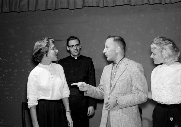St. James Catholic Theater players rehearse while Rev. Edmund Salzmann, spiritual director, looks on from the background. Actors are Phyllis Schuchardt, Tom Jafferis and Terry Ginter.