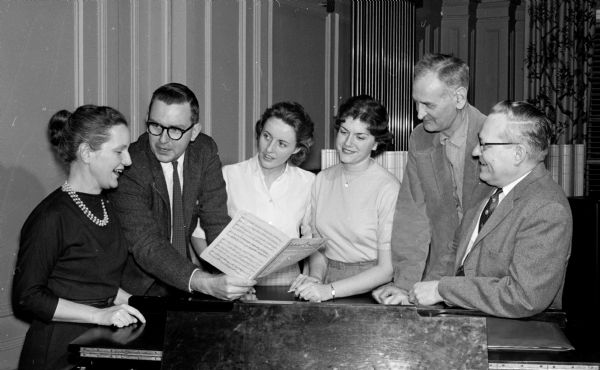 Officers of the Philharmonic Chorus of Madison prepare for the annual Christmas concert held in the Central High School auditorium. Officers shown (left to right) are Ruth Dickert, member-at-large; John Talbot, president; Ann Crosby, secretary; Virginia Gittens, vice-president; John Marshall, member-at-large; and Stanley Lenerz, chairman of the Prof. F.A. Ogg bequest to the chorus.