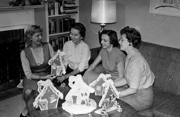 Busy with decorations for the annual Christmas dance are members of the Interns and Residents Wives club of the University of Wisconsin hospitals. Left to right are: Mrs. Inez McGrath, Mrs. Nancy Goldbeck, Mrs. Albert Kanner, and Mrs. Patricia Crocker.