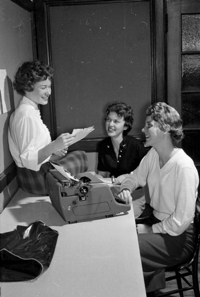 Three members of East High School newspaper's staff, the <i>Tower Times</i>, pose near a typewriter. They are Roberta Ruggles, Diane Stitgen and Karen Anderson.
