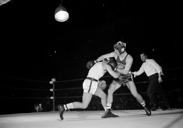 Action in the 139-pound second round match between Bernie Stein of Pittsburgh and Howard McCaffery of Wisconsin in the University of Wisconsin boxing Tournament of Contenders at the UW Fieldhouse.