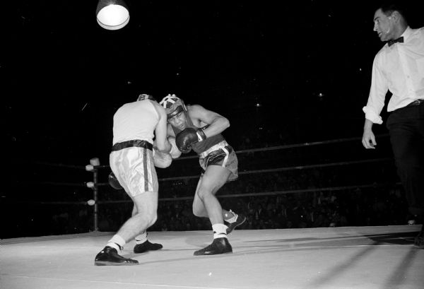 Action in the 147-pound third round match between Wisconsin's John Hampton and Gary Wilhelm of Pampa, Texas during the University of Wisconsin boxing Tournament of Contenders at the University of Wisconsin Fieldhouse.