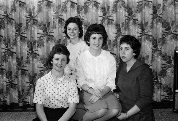 "Winter Rose" will be the theme of the Catholic Junior League's dance at the West Side Business Men's Club. Committee workers, left to right, are Barbara Palm, Mary Flad, Kathy Moore and Lou Ann Topp.