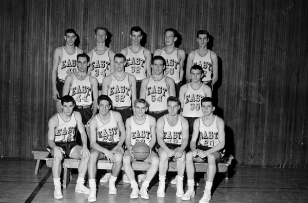 Group portrait of the Madison East High School basketball team.