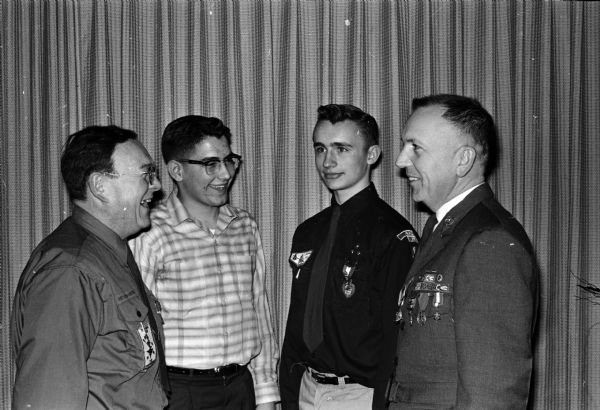 Eagle Scouts are honored at the first annual Eagle Scouts recognition banquet at the Madison Elk's Club. Shown (L-R) discussing the banquet  are: Lloyd Dillion, Cambridge scoutmaster; Curt Christensen, Cambridge; Bill Berge, and Maj. Max Rule.