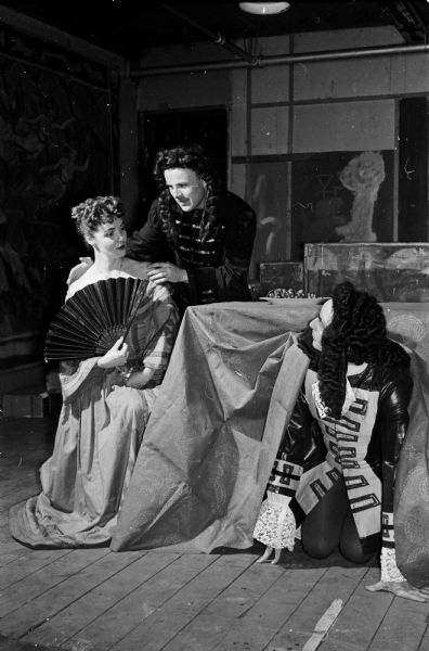 The Madison Theater Guild production of the Moliere comedy "Tartuffe" is presented at Madison West High School. Shown left to right are: Lois Klein, in the role of Elmire; Walker Reid, Tartuffe; and Seymour C. Levey, Orgon.