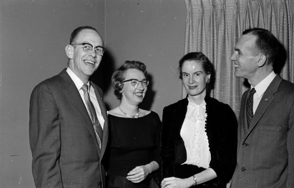 Two couples pose and chat at the dance. They are E.A. King, Ragna King, Joanne Rothe, and Ernell Rothe.