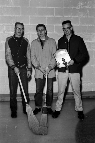 Portrait of three members of the John Curtis Rink from Madison West High School, winners of the third event in the Madison Invitational Prep Curling Bonspiel. They are, left to right: Carter Lueders, Larry Ozanne, and John Curtis.