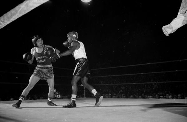 Action shot taken during a boxing match between Brown McGhee (right) of Wisconsin and Charley Johnson of Washington State.