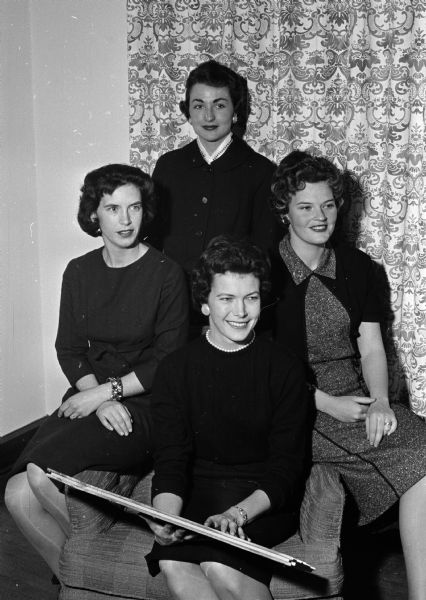 Group portrait of four committee members for the Kappa Alpha Theta alumnae group's benefit Aloha party. Seated are: Dr. Anne Gilfrey, Mrs. Elizabeth Green, and Mrs. Elizabeth Edgarton. Standing is Mrs. Judith Miller.
