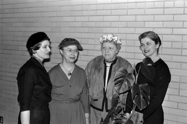 Four women converse at a display and sale of handicraft work made by disabled persons at the University League brunch. Left to right are: Mrs. William Scott, Mrs. Frederica Zdanowicz, Mrs. Rosa Fred, and Mrs. Aurelia Lacy.