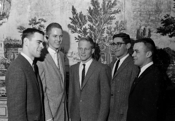 An open house for representatives of University of Wisconsin campus groups, housemothers, and alumni is held at the new Alpha Delta Phi fraternity house. Shown (left to right) are: William Trukenbrod, Winnetka, ILL, Beta Theta Pi; Don Lecher, Brookfield, WI, Alpha Delta Phi; Alan Cole, De Soto, WI, Beta Theta Pi; Robert Starzel, Larchmont, NY; and Richard Crotteau, Mosinee, WI, Lambda Chi Alpha.