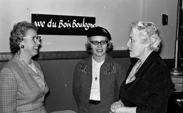 Three chairmen of the Opus Dei Fun-O-Rama charity event are on the "Rue du Bois Boulegne" which reflects the party's French theme. Left to right are: Mrs. Joseph (Frances) Weiler, 1521 Edgehill Drive and Mrs. Charles (Betty Claire) Haycock, 5417 Dahlen Drive, decorations chairmen; Mrs. Helen Oesterle, 2411 Monroe, Street, retreat chairman.