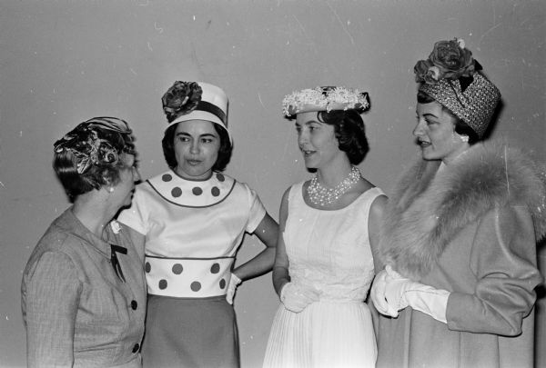 Mrs. George (Helen) Nichols, 3010 Harvard Drive, general chairman of the Opus Dei Fun-O-Rama charity event, left, talks with three members who modeled spring fashions at the style show. Left to right are: Mrs. William (Nancy) Draper, 5118 Loruth Terrace; Mrs. Edward (Patricia) Brucker, 4505 Herrick Lane, and Mrs. Robert (Rosemary) Shea, 4410 Cherokee Drive.