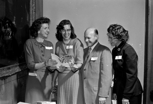 Many foster fathers also attended the Foster Parents Institute.  One of the couples, Mr. and Mrs. Clifford (Margaret) Loiselle, 2605 Spencer Lane, converses with Anita Flint, 3014 Union Street, left, staff member of the division for children and youth, chairman of the institute committee and Ann Clark, 729 West Johnson Street, staff member of the Children's Service Society.