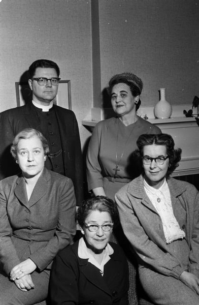Group portrait of five Madisonians involved in planning the spring meeting of the Episcopal Churchwomen, Northwest Convocation, Milwaukee Diocese to be held in Portage. Seated, left to right, are: Mrs. Anne Conners, Mrs. Annette Blied, and Mrs. Shirley Brumbaugh. Standing are: Rev. Paul Z. Hoornstra and Mrs. Eleanor Nerdrum.