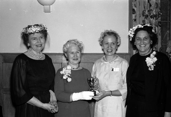 Group portrait of four women who attended the Ladies of the Press breakfast at the University Club. At left is toastmistress Mrs. Luella Mortenson and at right is guest speaker Mary Kimbrough of St. Louis, Missouri. Next to Mary Kimbrough is Mrs. June Brown who presented the annual Writer's Cup to Mrs. Martin Paust, Jr. of Richland Center, on her right.