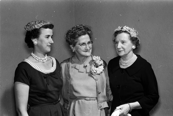 Group portrait of the current officers of the Madison Circuit of Women of the Evangelical Lutheran Church. Left to right are: Mrs. Ollis Davidson of DeForest, treasurer; Mrs. Lena Lerdahl of Madison, president; and Mrs. Earl Munson of Cambridge, vice-president. All three women wear pearl necklaces.