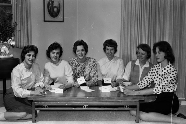Group portrait of six high school girls planning to attend the Inter-Sorority Council dance to raise money for charity. Left to right are: Kay Hoebel, Sharon Reynolds, Ann Haberman, Diane Savidusky, Jakie Gintz, and Maureen Schaefer.