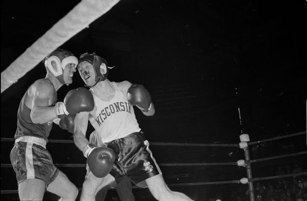 Wisconsin's Howard McCaffery (right) and Don Cruce of Ohio State in their Thursday bout during the NCAA boxing tournament at the University of Wisconsin field house. McCaffery won to advance to the semi-final round on Friday.