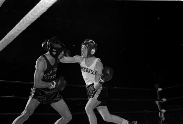 Wisconsin boxer Ellis Gasser (right) and Ron Nichols of San Jose State spar during their semi-final round bout during the NCAA boxing tournament at the University of Wisconsin field house. Gasser lost to the defending champion Nichols.