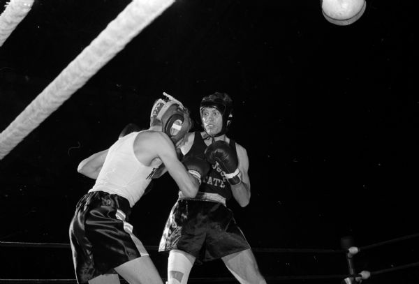Wisconsin boxer Dave Nelson (left) and John Drye of San Jose State participate in their semi-final bout during the NCAA boxing tournament at the University of Wisconsin field house. Nelson won by a TKO.