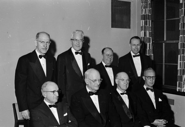 Group portrait of six men widely known in engineering and industry, who were presented with distinguished service citations by the University of Wisconsin at the annual Engineers' Day dinner. Also included are the presenters of the citations: Dean Kurt Wendt and university President Conrad A. Elvehjem. Rear row, left to right: Dean Wendt; Lynn Matthias, Allen Bradley Co. Milwaukee; Clifford Gladson, Ladish Co. Milwaukee; and President Elvehjem. Front row:  William Klinger, Sioux City, Iowa construction firm; Robert C. Allen, Allis-Chalmers, Milwaukee; Alexander Christie, John Hopkins University; and Ronald Copeland, National Concrete Masonry Association, Chicago Illinois.
