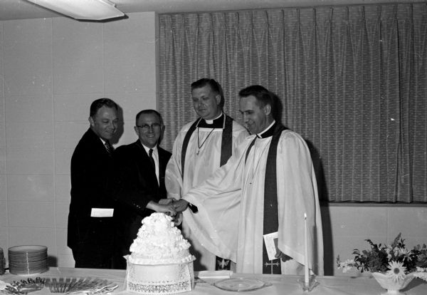 Two pastors and two laymen cutting a cake, probably at the consecration services at the new St. Stephen's Evangelical Lutheran Church, 5700 Pheasant Hill Road.