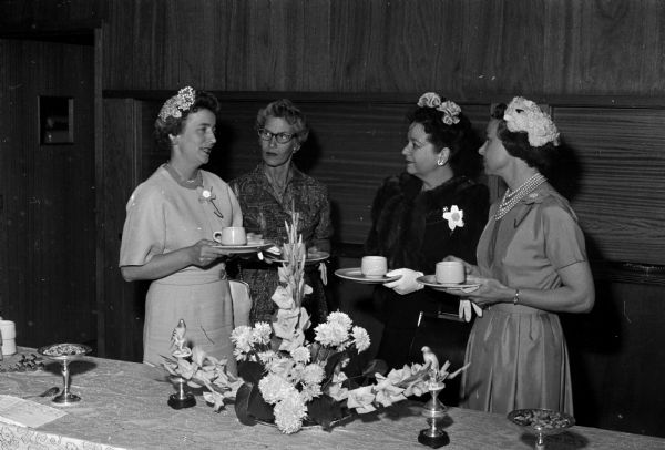 Marion Wilkie (left), Edith Leonard, Dorothy Sinykin, and Maryann Hanson attend a Nakoma Welfare League tea.