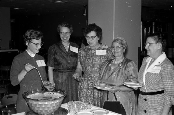Isabel Hughes serves punch to four women who have worked a total of 109 years at University Hospitals. Left to right are: Leone Duddleston with 23 years of service; Olive Littel with 23 years of service; Sarah Stassi with 30 years of service; and Mamie Ingebritten with 30 years of service.