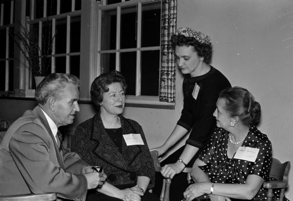 Roland Olson, who has worked at University Hospitals for 60 years, chats with Helen Crahen, second from left, and Ida Spiker, right, both of whom have worked there for 35 years. LaVerne Olson, Olson's wife, is second from right.