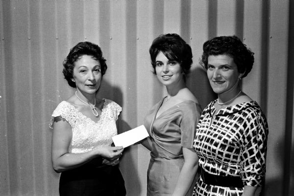 The Madison section of the National Council of Jewish Women awards a $200 scholarship to an outstanding Jewish high school senior girl from Madison who will attend the University of Wisconsin. Shown, left to right, are: Mrs. Louis Glass, Madison section president; Miss Madeleine Netboy, scholarship winner; and Mrs. Nathan Spector, chairman of the scholarship committee.