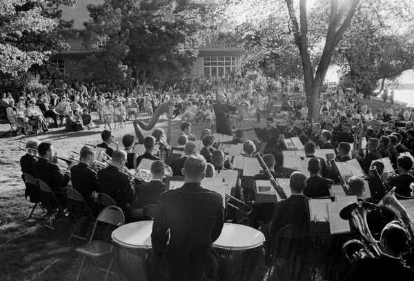 Raymond F. Dvorak, center, University of Wisconsin bands director, conducting the concert band at pre-commencement exercises on the Memorial Union Terrace.