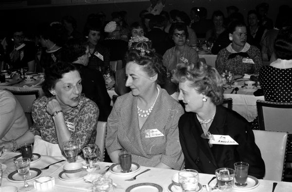Group portrait of three nurses ready to enjoy dinner at the Nurses Association spring banquet held at Welch's Embers. From left to right are: Mildred Brandt, Maud Gilbert, Iva Amundson.