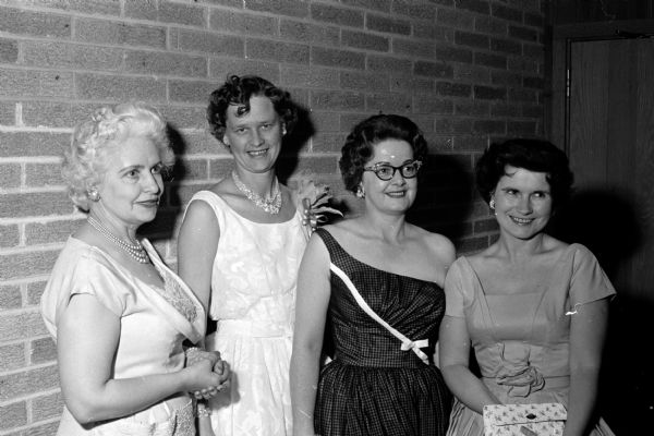 Hazel Van Wagenen (left), Delores Peck, Mrs. Robert Reese (Middleton), and Jeanne Anderson greet arriving guests at the East Side Women's Club for the annual spring banquet.