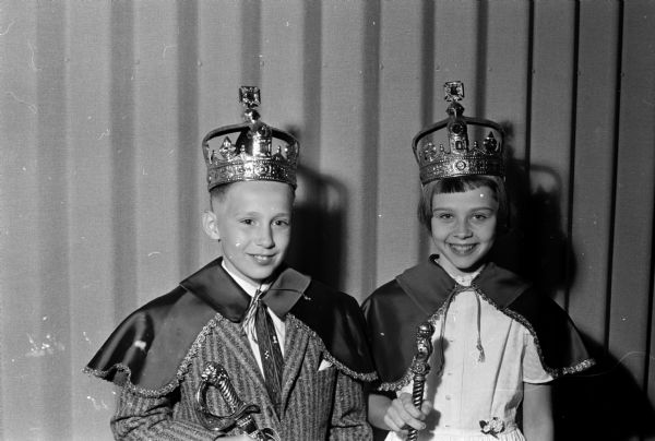King John Thacher and Queen Dianne Bystol posing while wearing crowns and capes. They were winners of the slogan contest.