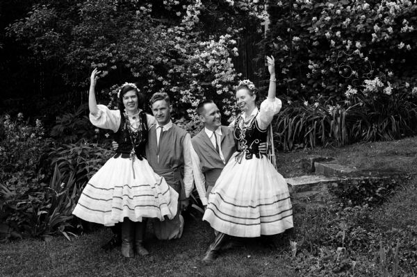 Four members of the Madison Folk Dancers, part of the YWCA dance program, perform at the YWCA garden tea in an annual benefit for the World Fellowship Fund. Left to right: Frances Kostka, Theo Konijn (U.W. student from Holland), David Anderson, and Patricia Roe.