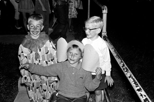 Children living at Sherman Terrace present "The Sad Sullivan Show" to their parents and friends at their outdoor theater to raise money for a new home for Winkie, the Vilas Zoo elephant. Shown from left to right are: Billy Roughton, clown; Jennifer Bloodgood, Winkie the elephant; and Scott Lee, elephant trainer.