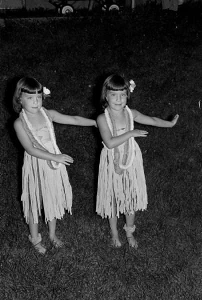 Children living at Sherman Terrace Apartments present "The Sad Sullivan Show" to their parents and friends at their outdoor theater to raise money for a new home for Winkie, the Vilas Zoo elephant. Highlighting the musical part of the show performing a hula dance and singing a Hawaiian song are Susie (left) and Cindy Clinkenbeard, twin daughters of Mr. and Mrs. Harlen Clinkenbeard.